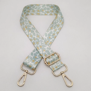Adjustable leopard print bag strap in blue and orange with golden metal hooks