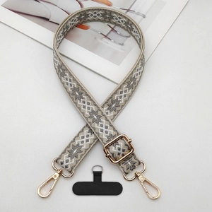 Detailed view of jacquard pattern strap with golden metal buckle and phone connector