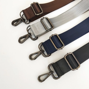 Detail of adjustable nylon shoulder straps with herringbone weave and gunmetal hooks
