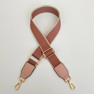 Detail of adjustable woven replacement shoulder strap with pink leather and gold lobster clips