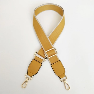 Detail of wide yellow woven replacement strap with gold lobster clasps and leather ends