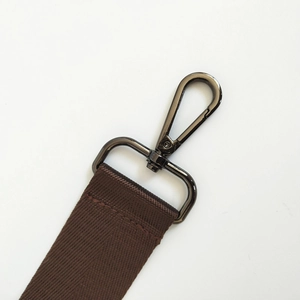 Close-up of adjustable brown nylon bag strap with gunmetal swivel lobster clasp hook