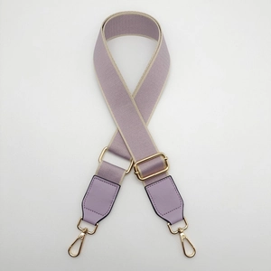 Detail of adjustable lavender wide shoulder strap with gold swivel hooks and beige trim