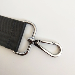 Detail of durable nylon bag strap featuring a polished silver swivel lobster clasp