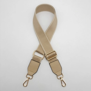 Detail of adjustable khaki woven shoulder strap with high-quality gold hardware buckles