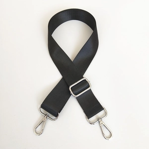 Close-up of adjustable black nylon bag strap with silver metal buckles and lobster clasps