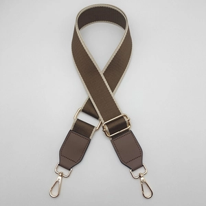 Detail of high-density woven wide shoulder strap with gold-plated metal swivel hooks