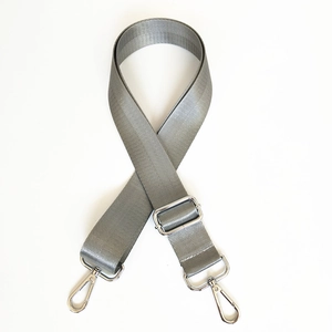 Macro detail of gray herringbone nylon strap with adjustable silver metal lobster clasps