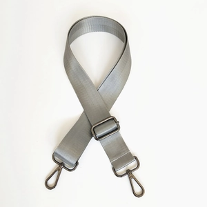 Close-up of grey nylon shoulder strap with metal buckle and herringbone texture