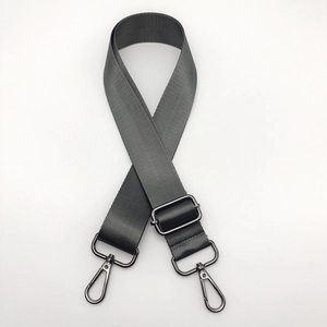 Macro shot of dark grey nylon shoulder strap with adjustable gunmetal swivel hooks
