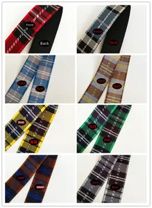 Detailed close-up of woven plaid bag straps in eight various classic British color patterns