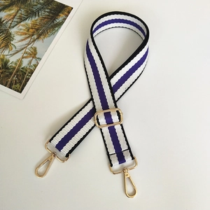Detail of adjustable purple and white striped woven bag strap with gold metal hooks