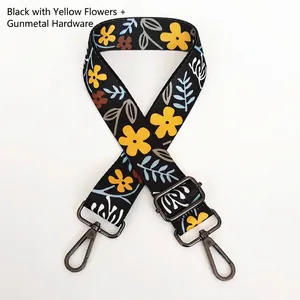 Detailed view of adjustable floral shoulder strap with black webbing and gunmetal hooks
