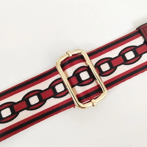 Macro shot of retro chain-pattern jacquard bag strap with gold metal buckle