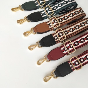 Detail view of colorful wide canvas replacement straps with gold metal lobster clasps