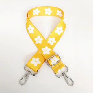 Detail of adjustable yellow floral replacement strap with silver metal swivel hooks