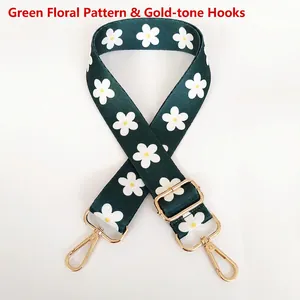 Close-up of adjustable dark green shoulder strap with daisy pattern and gold hooks