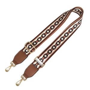 Adjustable wide shoulder strap with beige and brown geometric pattern and gold buckles