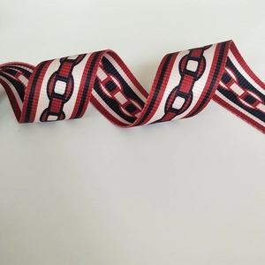 Close-up of red and navy blue geometric chain pattern woven handbag shoulder strap
