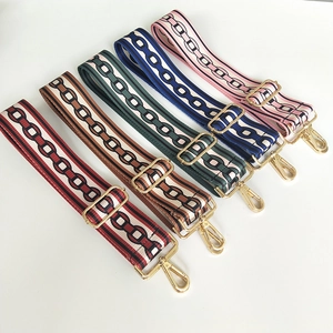 Detail view of five colorful ethnic style woven bag straps with golden metal buckles