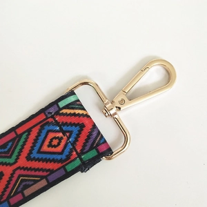 Detail of adjustable ethnic geometric woven strap with premium gold metal swivel clasp