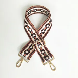 Adjustable brown and beige woven bag strap with golden metal hooks and chain pattern