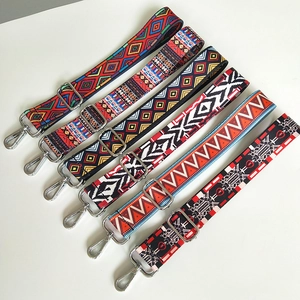 Detail of adjustable wide canvas shoulder straps with ethnic patterns and silver clips