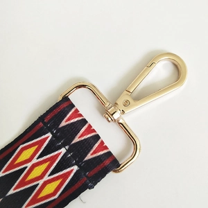 Detail of 5cm wide geometric ethnic weave strap with golden swivel lobster clasp