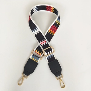 Detail of adjustable ethnic geometric strap with gold metal hooks and leather ends