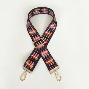 Adjustable red diamond patterned woven shoulder strap with gold swivel metal hooks