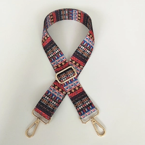 Close-up of bohemian style geometric woven strap with golden alloy swivel hooks
