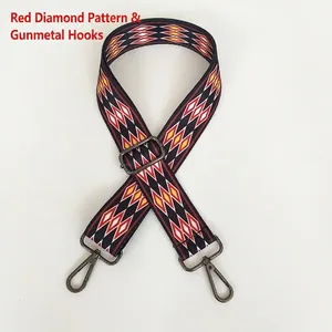 Detail of red diamond pattern woven bag strap with adjustable gunmetal swivel hooks