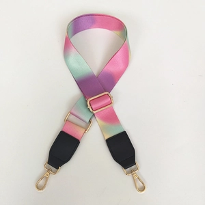 Detail of adjustable colorful gradient bag strap with gold metal hooks and black leather ends