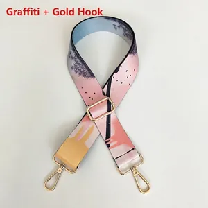 Close-up of adjustable graffiti style shoulder strap with high-gloss gold metal hooks