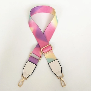 Detail of adjustable rainbow shoulder strap with gold hardware and white leather ends
