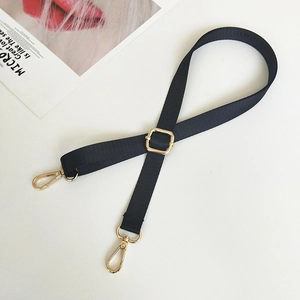 Detail of adjustable black nylon shoulder strap with premium golden metal buckles