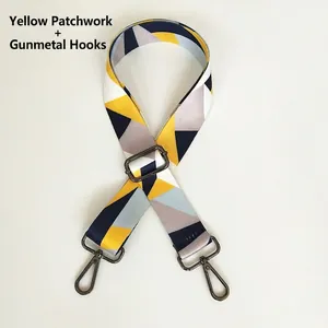 Detail of yellow geometric patchwork shoulder strap with gunmetal swivel snap hooks