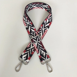 Detail of geometric pattern bag strap with silver metal buckles and lobster clasps