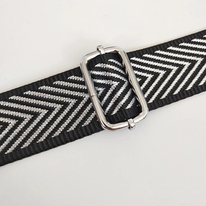 Detail of black and silver herringbone jacquard strap with metal adjustable buckle
