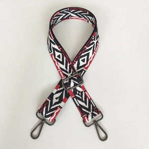 Detail of red and black geometric ethnic canvas strap with gunmetal swivel hooks