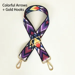 Detail of colorful geometric arrow pattern strap with gold metal hooks and buckle