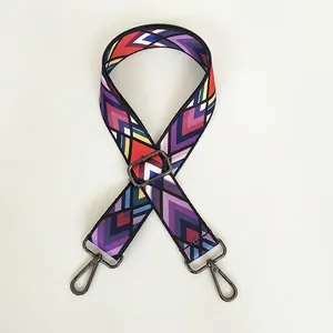 Detail of adjustable wide shoulder strap with colorful geometric arrow pattern and metal hooks