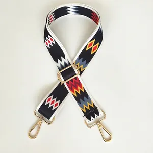 Close-up of colorful wave pattern fabric strap with gold metal hooks and adjustable buckle