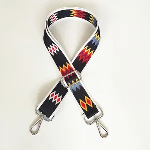Close-up of adjustable wide shoulder strap with silver metal hooks and zigzag pattern