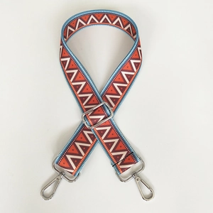 Detail of bohemian geometric woven shoulder strap with silver rotating metal buckles