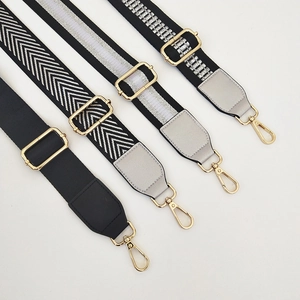 Close-up of four adjustable wide bag straps with gold hardware and stylish weave patterns