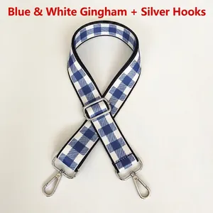 Detailed shot of blue gingham fabric strap with silver metal swivel hooks and adjuster