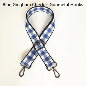 Detail of adjustable blue and white gingham bag strap with gunmetal swivel snap hooks
