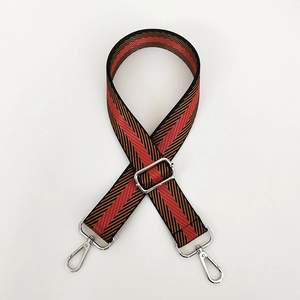 Close-up of adjustable woven strap featuring red and black chevron patterns with silver hooks