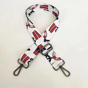 Close-up of adjustable crossbody strap with nautical prints and gunmetal lobster clasps